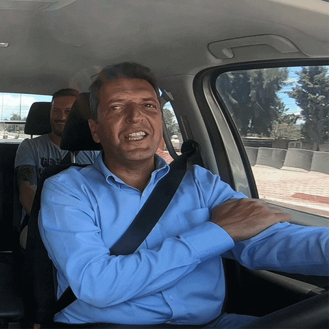 Video gif. A middle-aged man smiles as he drives while animated sunglasses lower down to cover his eyes. 