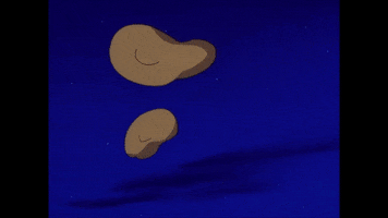 TV gif. Treats are tossed in the air and Scooby-Doo jumps up to catch them in his mouth.
