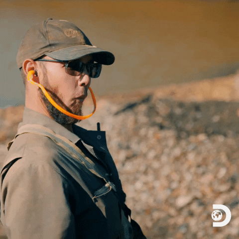 TV gif. Kevin Beets from Gold Rush with a surprised but excited expression high fives another person.