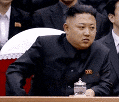 Political gif. Kim Jong-Un at an assembly, clapping and nodding.