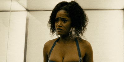 Movie gif. Wearing a bustier-bodysuit, Keke Palmer as Mercedes in "Hustlers" shouts and then runs away through a wet parking lot.