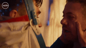 TV gif. Gazing at each other with astonishment, Matthew McNulty as Adam in Doctor Who tenderly holds the face of Warren Brown as Jake and says, "I hate you," and then they kiss.