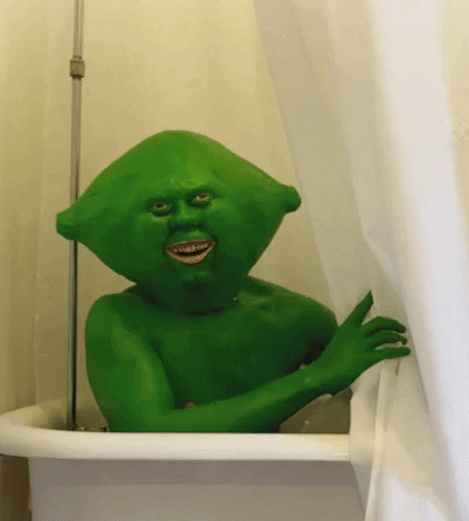 Video gif. A person dressed to look like a green alien sits in a bathtub and smiles before pulling the shower curtain closed. Text, "K, bye."