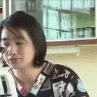 Video gif. A woman backs away from a microscope with a flat, unimpressed face. Text, "mmm-hmmm."
