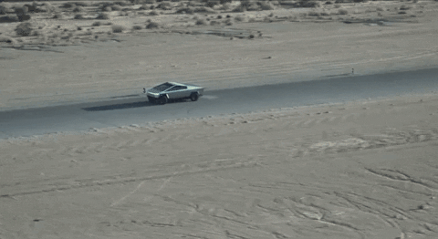 Gif of a Cybertruck driving through the desert.