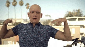 TV gif. During a sunny day in LA, Anthony Carrigan as NoHo Hank from Barry quickly fans himself in the face and exhales before shaking his head to snap out of it.
