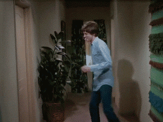An animated gif of Eric from That '70s Show - he winds up to kick an apartment door and then falls backwards into the wall behind him and slides down it.