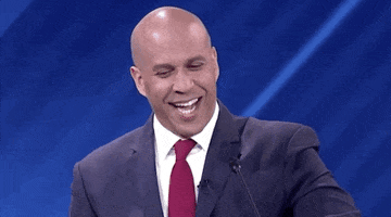 Video gif. Cory Booker stands behind a microphone as he smiles smugly and speaks to someone unseen. Text, "First of all I want to say no. Actually, I want to translate that into Spanish. No."