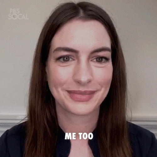 Celebrity gif. Anne Hathaway looks at us shaking her head and smiling as she says, “Me too.”