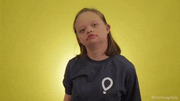 Video gif. A young girl adopts the Thinker pose, finger to her chin, eyes looking upward in searching consideration.