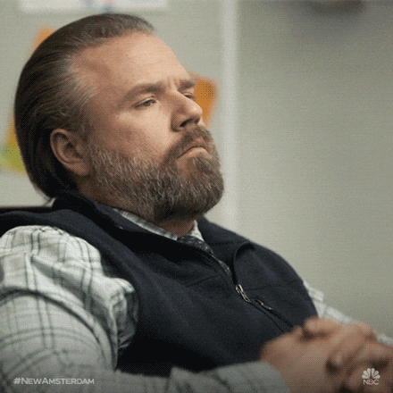 TV gif. Tyler Sean Labine as Doctor Iggy Frome from New Amsterdam leans back in a chair with his arms propped up high on arm rests. His eyebrows are knotted and he blinks quickly as he thinks hard. He brings his hand up to his face to rest his face as he contemplates.