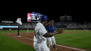 Sports gif. Christopher Morel of the Cubs runs full speed to home and does a big jump to stomp down on home plate. His teammates are all gathered there and jump around him as they celebrate the run. 