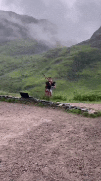 scottish bagpiper wearing tartan in scotland 