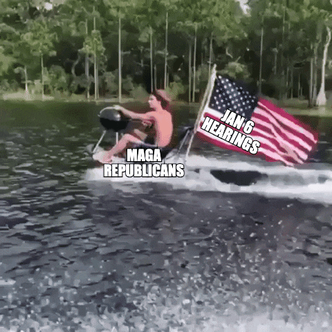 Video gif. Man labeled “MAGA Republicans” rides on a jet ski retrofitted with a BBQ labeled “Fox News” and an American flag labeled “Jan 6 Hearings.” As he moves across the water, he opens the BBQ, and smoke pours out of it into his face.