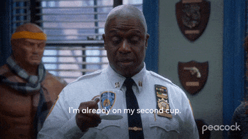 TV gif. Andre Braugher as Captain Holt in Brooklyn Nine-Nine lifts a mug to his mouth as he says, "I'm already on my second cup."