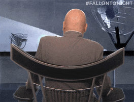 Movie gif. Mike Myers as Dr. Evil from Austin Powers spins around in a chair to face us before laughing uproariously in his usual evil style.