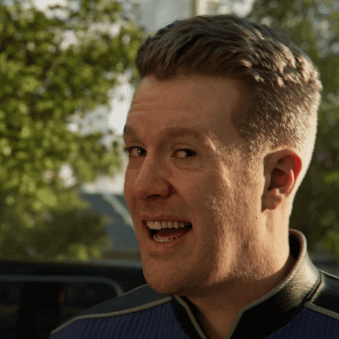 Video game gif. Closeup of a man in a blue Starfleet uniform as he turns towards us and his mouth drops and his eyes widen in shock.