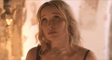Movie gif. Julie Delpy as Celine in the Before trilogy, looking up penitently, crossing herself and then pressing her hands together in prayer.