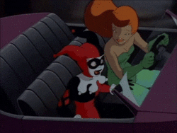 Cartoon gif. Driving a top-down convertible, Poison Ivy high fives passenger Harley Quinn, who leans back victoriously.