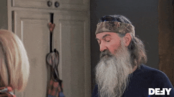 Reality TV gif. Wearing sunglasses on his head over a camouflage headband, Phil Robertson of Duck Dynasty closes his eyes and gives a thumbs up.