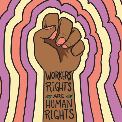 Digital art gif. A fist of solidarity, rings of color radiating outward, text on the inside of the wrist and forearm like a tattoo reads, "Worker's rights are human rights."