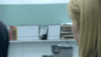 TV gif. Peter Capaldi as Malcolm in The Thick of It. He's walking away but stops and he turns his head back slowly, facing a woman with a shocked look on his face.