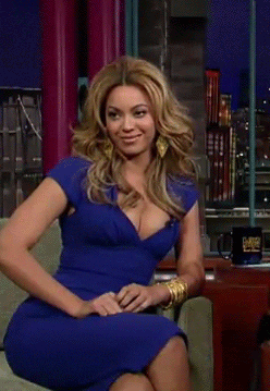 Celebrity gif. Beyoncé smiles then gradually leans into a laugh before tossing her head back with a sweep of her hair.