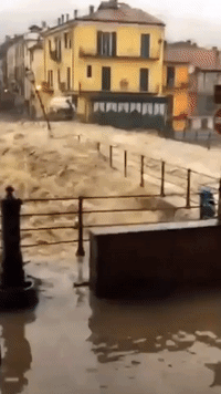 River Swells Dangerously Over Bridge in North Italian Town of Garessio