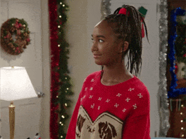 Ad gif. Teenage girl in Christmas sweater inches back uncomfortably and raises her eyebrows.
