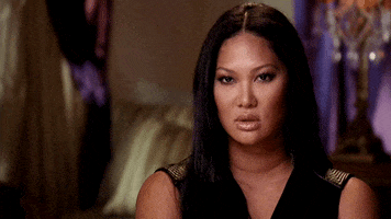 Reality TV gif. Kimora Lee Simmons on Life in the Fab Lane looks at us and tilts her head down to give us an annoyed glare. 