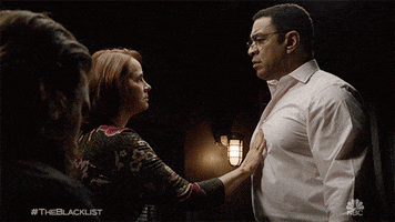TV gif. Woman on The Blacklist holds her hand on Harry Lennix as Harold Cooper’s chest. He looks around and shifts uncomfortably.