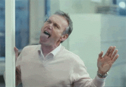 Video gif. A deranged office worker, palms against a glass divider, makes a show of bawdily licking the glass.