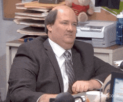 The Office gif. Zoom in on an angry, disappointed Brian Baumgartner as Kevin sitting at his desk. His eyes move from one side to look at us.