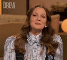 TV gif. Clip of Drew Barrymore on the "Drew Barrymore Show" holding up a finger like, "Give me a sec," before breaking down in laughter. 