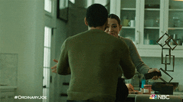 TV gif. Charlie Barnett as Eric Payne on Ordinary Joe picks up Natalie Martinez as May Kindelan by the waist and twirls her around. May embraces him happily. 
