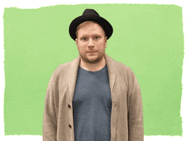 Celebrity gif. A hopeful Patrick Stump from Fall Out Boy crosses both fingers in anticipation.