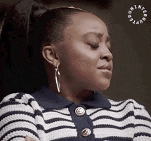 TV gif. Quinta Brunson as Janine in Abbott Elementary. She looks annoyed as she leans back in her chair with crossed arms and rolls her eyes heavily.