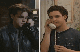 TV gif. A split screen phone conversation of Ben Savage as Cory and Rider Strong as Shawn in Boy Meets World, each lowering the phone receiver sadly, then both return it to their ear, listening hopefully.