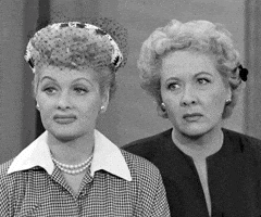 TV gif. Lucille Ball as Lucy tilts her head, raises her eyebrows, and frowns skeptically while Vivian Vance as Ethel glances to the side uncertainly beside her.