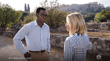 TV gif. Kristen Bell and William Jackson Harper as Eleanor and Chidi on the Good Place missing each other's half-hearted high five.