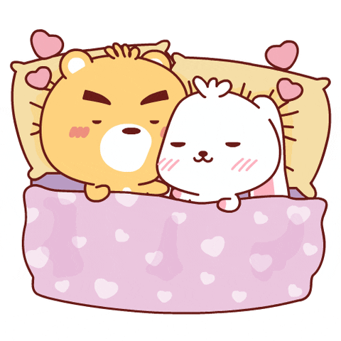 Cartoon gif. Hearts float above a chibi bear and rabbit, who are cuddled up in bed together and blushing.