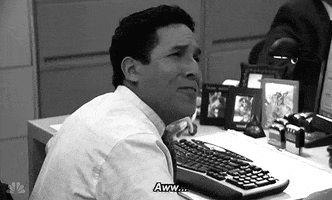 The Office gif. Oscar Nunez as Oscar faking endearment and saying "Aww..." before turning away and looking straight-faced at his computer. 