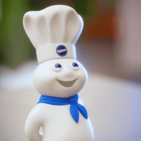 Sponsored gif. The Pillsbury Doughboy, in his iconic blue scarf and Pillsbury chef hat, giggles and covers his mouth with his hands. 