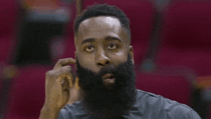 Sports gif. James Harden looks around confused, scratching his head with a finger, his mouth pulled to one side.