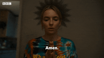 TV gif. Jodie Comer as Villanelle in Killing Eve holds her hands in front of her in prayer, bows her head and says, “Amen.”