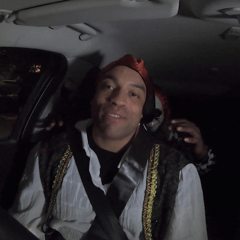Video gif. Man dressed as a pirate talks to us in his car, unbeknownst to a masked clown lurking in the dark. The clown suddenly grabs him by the shoulders, making him scream.