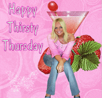 Digital art gif. Woman with blonde hair sits in front of a giant martini glass and strawberries against a pink background with glitter, bubbles, and a butterfly. Text reads, "Happy Thirsty Thursday."