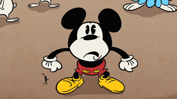 Disney gif. Mickey from Mickey's 90th Spectacular clutches his head and scratches as he ponders the situation. We zoom into his face and as he figures it out, his eyes popping open.