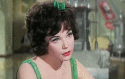 Celebrity gif. Shirley MacLaine stares at something in thought and she takes a deep breath as she comes to a realization. She looks down and scrunches her eyebrows again.
