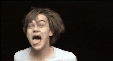 Celebrity gif. Young Leonardo DiCaprio sticks out his tongue, laughing maniacally.